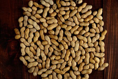 Peanuts on a dark background. Peanuts in the shell. Healthy food.の写真素材