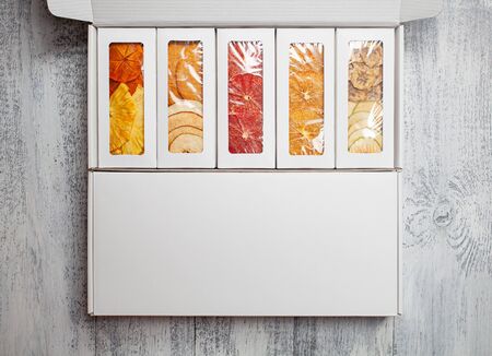 Boxes of fruit chips lie on a white wooden backgroundの写真素材