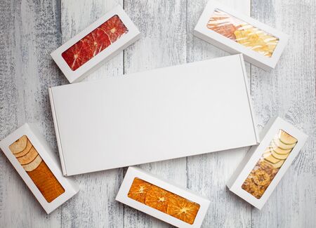 Boxes of fruit chips lie on a white wooden backgroundの写真素材