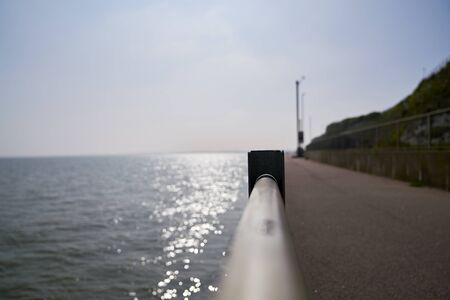 division between the sea and the pathの写真素材