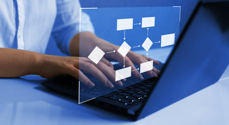 Businesswoman working on laptop in office, closeup. Technology concept