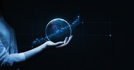 Close up of businesswoman hand holding glowing globe with graphs and diagrams