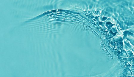 close up of water ripples on a blue background with copy space