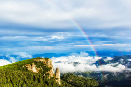Rainbow over the mountain,Ceahlau massif, Eastern Carpathians, Moldova, Romaniaの写真素材