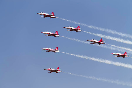 Seven Turkish airplanes in the sky at an air show