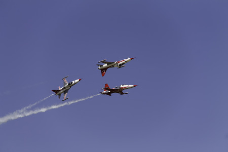 Three Turkish airplanes in the sky at an air show