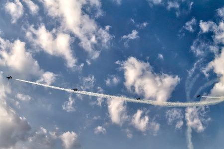 Four airplanes in the sky at an air show