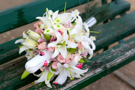 Beautiful bouquet of pink roses,lilies and chrysanthemums on a candle decorated with ladybugs and mushroomsの写真素材