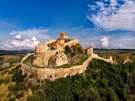 Beautiful aerial view of the Rupea Stronghold on a blue sky with white clouds, Rupea, Brasov, Romaniaの写真素材