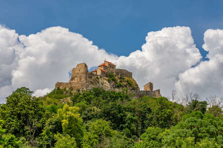 Beautiful view of the Rupea Stronghold on a blue sky with white clouds, Rupea, Brasov, Romania