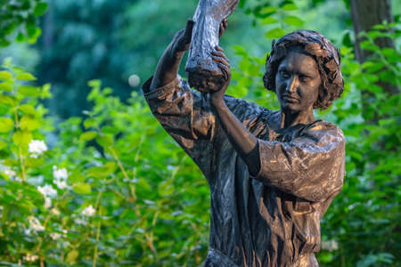 Bucharest, Romania - May 23,2018, Woman holding a wooden log, Living Statues, Street Theater Festival, Cismigiu Parkのeditorial素材