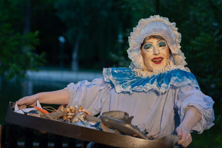 Bucharest, Romania - May 24,2018, The fish seller, Living Statues, Street Theater Festival, Cismigiu Parkのeditorial素材