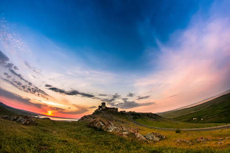 Beautiful landscape and a sunset sky over Enisala old stronghold citadel,Dobrogea,Romaniaの写真素材