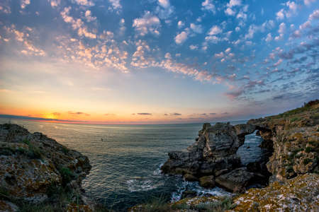 Beautiful sunrise over the Black Sea with rocks on the shore, Tyulenovo, Bulgariaの写真素材