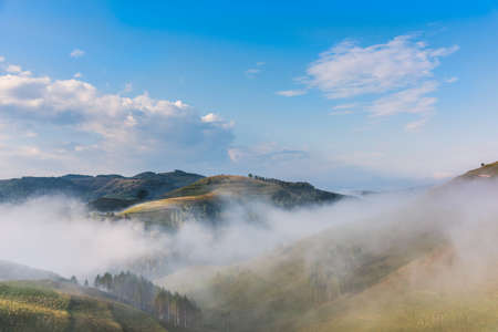 Beautiful mountain landscape of a foggy morning with trees and clouds, Dumesti, Salciua, Apuseni,...