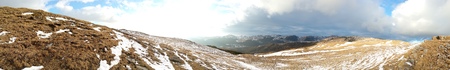 Mountain top panorama at sunset on a warm winter evening near Sinaia, Romania
