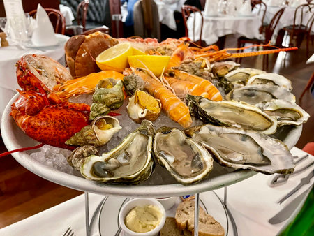 Platter of delicious seafood accompanied by mayonnaise sauce and two slices of lemonの写真素材