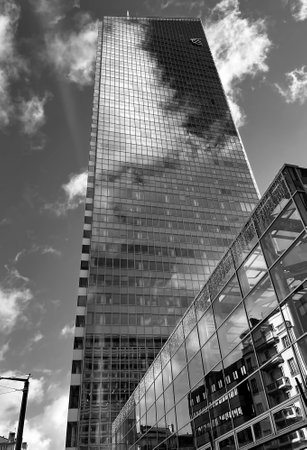 A very tall glass building in black and whiteの写真素材