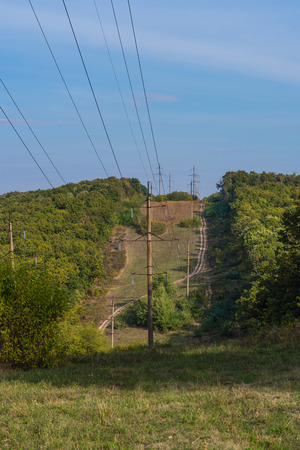Power line passing through the forest. High voltage . Delivering electricity.の写真素材