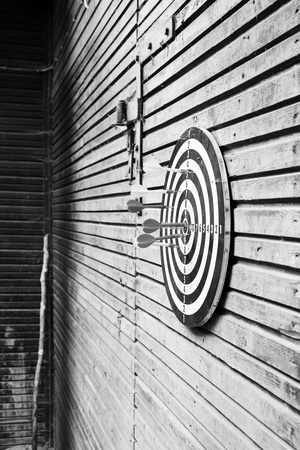 Dartboard on wood wall の写真素材