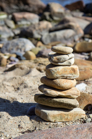 Stone tower. Natural pebble stone on the beach. Balancing body, mind, soul and spirit. Mental health.の写真素材