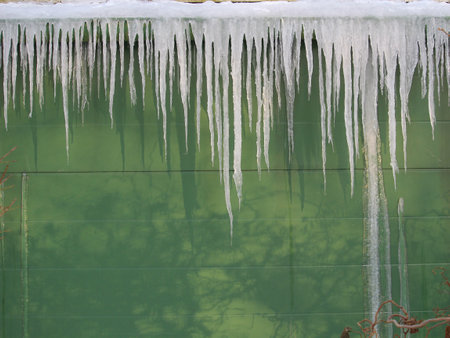 Icecles hanging from a roof. Energy lossの写真素材