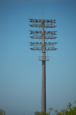 Sports stadium lighting system. The lights of a football stadium, are not in use. Light tower with many luminous projectors to illuminate the night sports event at the stadium.の写真素材