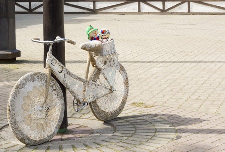 retro bike decorated with embroidery and soft doll in a basket.の写真素材