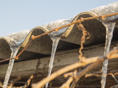 icicles which are hanging down from a roofの写真素材