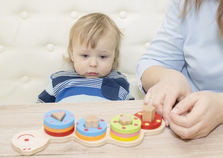 little boy and his mom play in developing the gameの写真素材