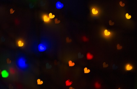 blurry bright background abstraction with coloured heartsの写真素材