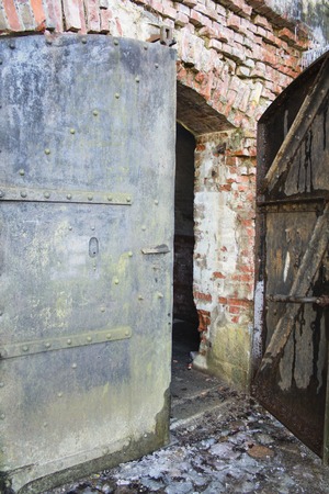 An old metal door in the brick wall.