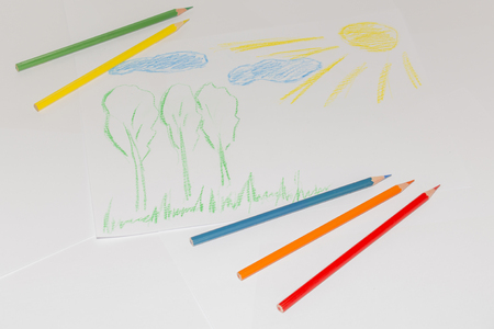 Childs color drawing on a white paper with color pencilsの写真素材