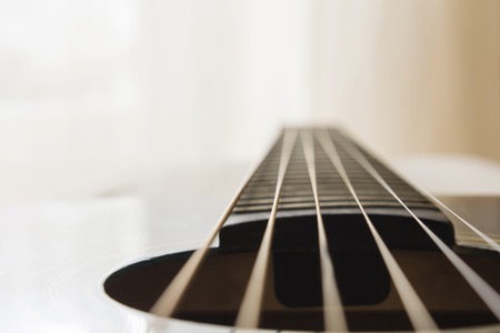 Selective focus, macro lens, shooting retro classic vintage guitar, focus on strings.