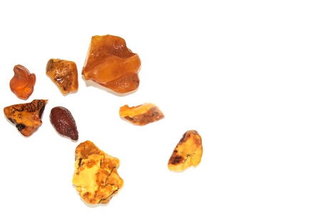 Eight different pieces of amber on a white background. Amber of various colors and structure and shapes. Transparent and opaque pieces of amber. Natural amberの写真素材