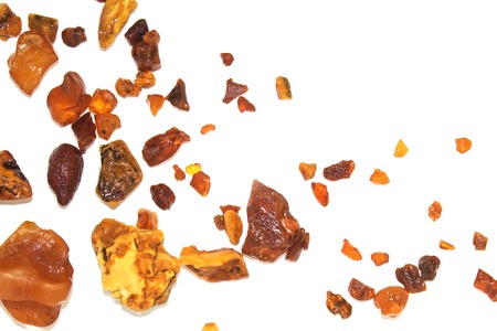 Eight different pieces of amber on a white background. Amber of various colors and structure and...