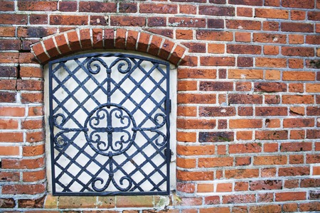 The wall with window of broken and abandoned red brick house.の写真素材