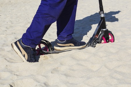 The scooter stalled in the sand.の写真素材