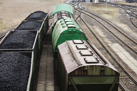 Aerial view on wagons with black coal. Coal transportation