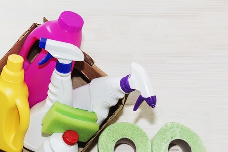 Detergents bottles, on wooden background light, close-up