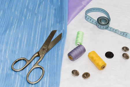 Background of sewing: scissors, thread, needles, measuring tape close up top viewの写真素材