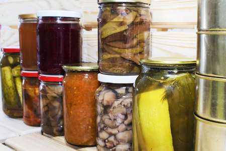 Storage shelves in pantry with homemade canned preserved fruits and vegetables.の写真素材