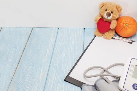 pressure measurement, red heart and bear on blue background with red heart,の写真素材