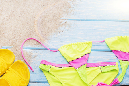 bright bikini on the sand, yellow shale.の写真素材