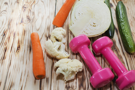 Fitness concept with dumbbells and healthy food. Vegetarianism in the sport.の写真素材