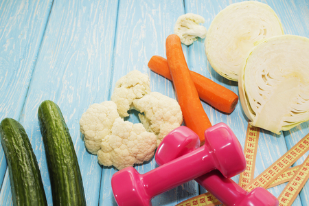 Fitness concept with dumbbells and healthy food. Vegetarianism in the sport.の写真素材