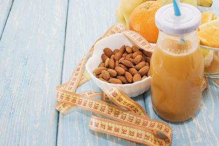 Diet, healthy and active lifestyle concept, apples, bananas, tape measure, juice bottle, with blank copy spaceの写真素材