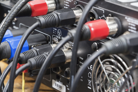 audio jack and wires connected to audio mixer, music dj equipment at concert, festival, bar