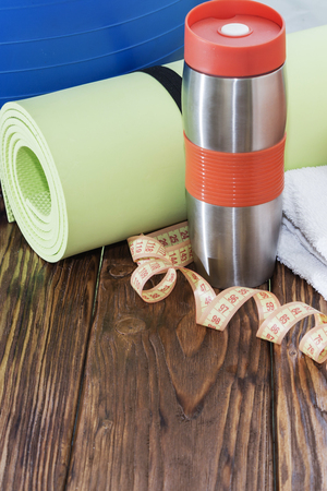 Sports equipment, Fit ball, yoga mat, and water bottle close upの写真素材