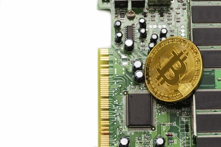 Bitcoin mining process - gold coin on computer circuit board with bitcoin processor and microchips. Electronic currency, internet finance rypto currency concept.の写真素材